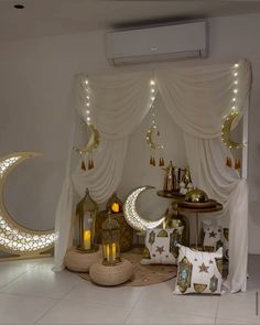 a living room filled with lots of furniture and decor on top of a white floor