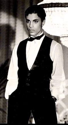 a black and white photo of a man in a tuxedo