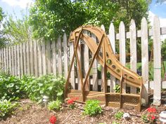 a wooden slide in the middle of a garden