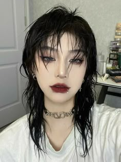 a woman with black hair and piercings on her head wearing a choker necklace