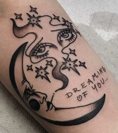 a black and white tattoo on the leg of a person with stars around her head