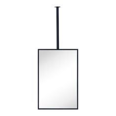 a square mirror hanging from the side of a pole with a light on top of it