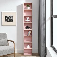 a living room with a chair and book shelf