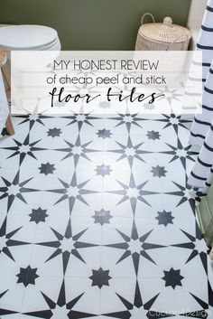 a bathroom floor with black and white tiles on it, the words my honest review of cheap peel and stick floor tiles