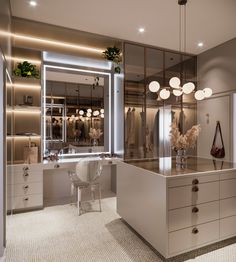 an elegant dressing room with mirrored walls and lights on the ceiling is lit by two pendant lights