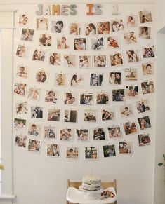 a white wall with many pictures hanging on it's side and a table in front of it