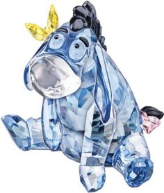 a glass horse with a man sitting on it's back next to its head