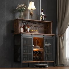 an open cabinet with bottles and glasses on it