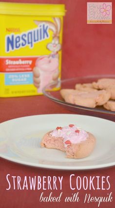 strawberry cookies are on a plate next to a container of yogurt