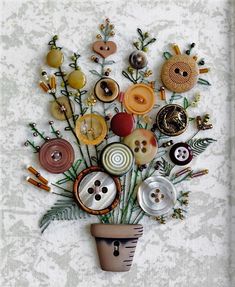 a vase filled with lots of different buttons and pins on top of a white wall