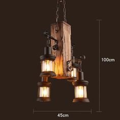 three lights hanging from a wooden beam