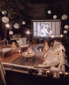 a living room filled with lots of furniture and lights on top of a wooden floor