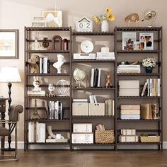 a book shelf filled with lots of books on top of a hard wood floor next to a lamp