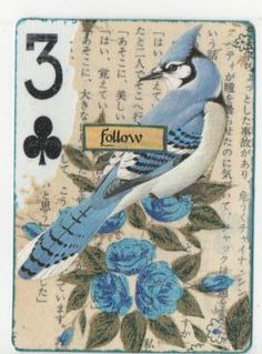 a blue bird sitting on top of a card with flowers and leaves around it's edges