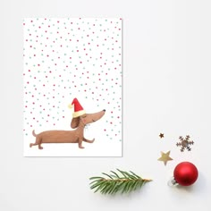 a christmas card with a dachshund dog wearing a santa hat on it