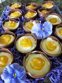 an arrangement of deviled eggs in bowls with blue flowers