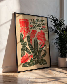 a framed poster is sitting on the floor next to a potted plant