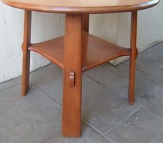 a wooden table sitting on top of a tile floor