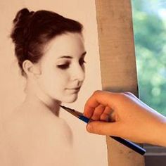 a person holding a pair of scissors in front of a photo