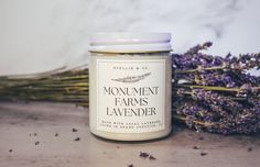 a jar of lavender sits next to some flowers