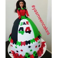 a birthday cake with a doll on top