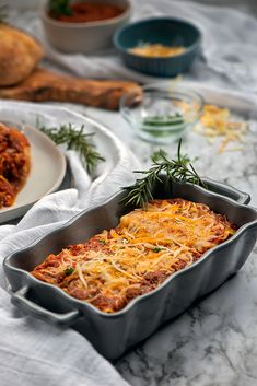 a casserole dish with cheese and herbs