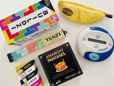 an alarm clock, banana, book, and other items on a table with the words anarcy pancakes