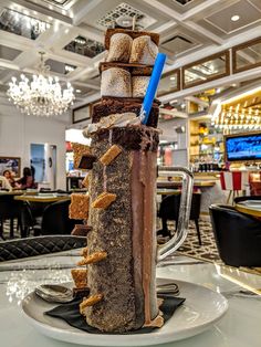 there is a tall chocolate dessert on the table