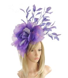 Hats By Cressida Ascot Fascinators, Wedding Hats & Kentucky Derby Hats Purple & Lilac Hayley Feather and Silk Fascinator Hat A mass of purple feathers surround a large purple silk rose flower Flower is about 10 inches wide, feathers about 8-10 inches We can do this in many colours Mounted with a matching headband. If you prefer a headband to match your hair, please make a note at check out what colour headband you want. The Hayley Fascinator Hat is perfect for any special occasion, whether it's a glamorous horse race like the Kentucky Derby or a formal affair like Royal Ascot. This stunning hat features a large silk rose flower, surrounded by a gorgeous mass of feathers, making it a truly elegant headpiece. It's perfect for the mother of the bride or any woman in need of a formal hat. The Fitted Purple Hat For Spring, Fitted Purple Hat For Kentucky Derby, Fitted Lavender Hats For Spring, Lavender Fitted Hat For Spring, Fitted Lavender Hat For Spring, Purple Mini Hats For Summer Church Events, Purple Mini Hats For Church In Summer, Purple Mini Hats For Summer Church, Adjustable Purple Costume Hats And Headpieces For Church