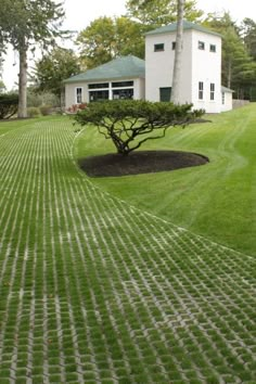 a white house sitting on top of a lush green field