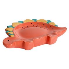 an orange and green alligator shaped dish on a white background