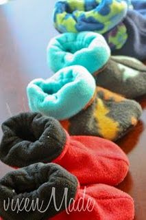 five pairs of slippers sitting on top of a wooden table