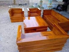 several wooden benches sitting on top of a cement ground