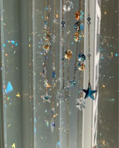 a wind chime hanging from the side of a window with lots of stars on it