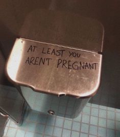 a sign that says at least you aren't pregnant on the side of a toilet