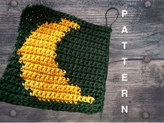 a green and yellow crocheted potholder with the word pattern on it