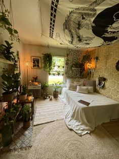 a bed room with a neatly made bed and lots of plants