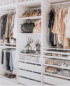 an organized closet with clothes, shoes and handbags on shelve shelves in white