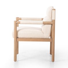 a wooden chair with a white upholstered back and armrest, on a white background