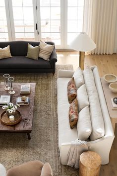 a living room filled with furniture and lots of windows