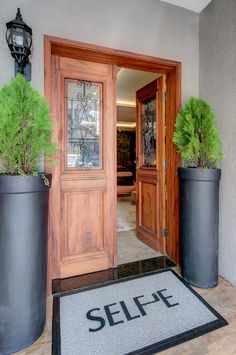 two large planters are on the front door