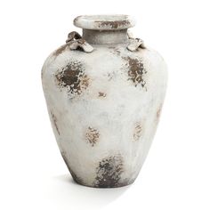 an old white vase with brown spots on the top and bottom, sitting against a white background