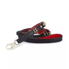 a black and red leash with silver hardwares on the ends is shown in front of a white background