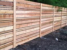 a wooden fence is lined with gravel