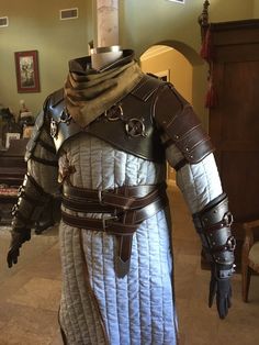 a man dressed in armor standing next to a table