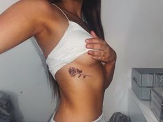 a woman with a rose tattoo on her stomach