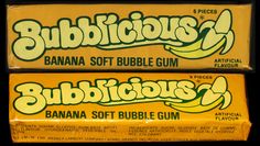 two bars of bubble gum sitting next to each other on a black surface, one yellow and the other green