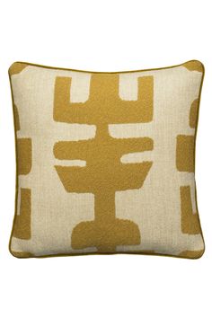 a yellow and white pillow with an abstract design on the front, sitting on a white surface