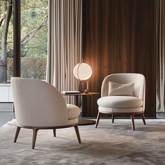 two chairs sitting next to each other on top of a rug