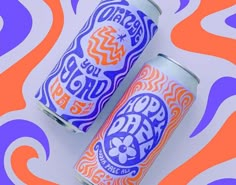 two cans of beer sitting on top of an orange and purple wave design pattern background